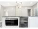 Kitchen island featuring granite countertops, a built-in microwave, and a beverage refrigerator at 1933 Koehne St, Indianapolis, IN 46202