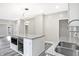 Bright kitchen featuring a modern island with a built-in beverage cooler and gray cabinets at 1933 Koehne St, Indianapolis, IN 46202