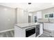 Modern kitchen featuring a stylish island with granite countertop and stainless steel appliances at 1933 Koehne St, Indianapolis, IN 46202