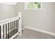 Staircase with carpeted steps, and white painted newel posts and balusters at 1933 Koehne St, Indianapolis, IN 46202