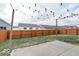 Large, fenced backyard with a concrete patio and decorative string lights at 2452 Bristol Dr, Franklin, IN 46131