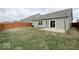 A spacious backyard featuring well-maintained lawn, wood fencing, and a small patio at 2452 Bristol Dr, Franklin, IN 46131