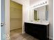 Modern bathroom with double sinks, a dark vanity, and open shelving, offering convenient storage at 2452 Bristol Dr, Franklin, IN 46131