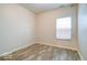 Bright room with wood-look floors, neutral walls, and a bright window at 2452 Bristol Dr, Franklin, IN 46131