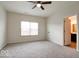 Bright room with carpet and a ceiling fan. Doorway to a bathroom at 2452 Bristol Dr, Franklin, IN 46131