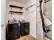 Functional laundry room with modern washer and dryer and convenient open shelving at 2452 Bristol Dr, Franklin, IN 46131