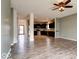 Open-concept living room with vinyl plank floors, a ceiling fan, and natural light, perfect for entertaining at 2452 Bristol Dr, Franklin, IN 46131