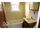 Cozy bathroom featuring a tiled shower-tub combination and vanity with a sink at 305 Mohawk St, Anderson, IN 46012