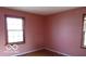 Neutral bedroom featuring two windows and wood floors at 305 Mohawk St, Anderson, IN 46012