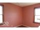 Empty bedroom features dual windows and hardwood flooring at 305 Mohawk St, Anderson, IN 46012