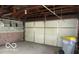 Spacious garage with ample storage and a large overhead door at 305 Mohawk St, Anderson, IN 46012