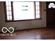 Sunlit living room featuring hardwood floors and large windows providing ample natural light at 305 Mohawk St, Anderson, IN 46012