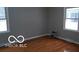 A well lit bedroom with two windows and wood floors at 3121 W 13Th St, Anderson, IN 46011