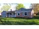 Charming brick home with lush green lawn and mature trees creating a welcoming curb appeal at 3121 W 13Th St, Anderson, IN 46011