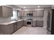 Modern kitchen features stainless steel appliances, gray cabinets, and marble countertops at 3121 W 13Th St, Anderson, IN 46011