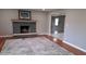 Bright living room features brick fireplace and hardwood floors at 3121 W 13Th St, Anderson, IN 46011