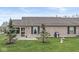 Spacious backyard with green lawn, patio, and mature landscaping at 4038 Oak Trail Dr, Indianapolis, IN 46237