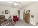 This carpeted bedroom offers a ceiling fan and an additional living space with a recliner at 4038 Oak Trail Dr, Indianapolis, IN 46237