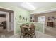 Charming dining area with wood table and chairs, wainscotting, and entryways to other rooms at 4038 Oak Trail Dr, Indianapolis, IN 46237