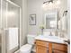 Bright bathroom featuring a glass shower door and wooden vanity at 4619 Churchill Downs Cir, Greenwood, IN 46143