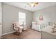Charming Bedroom with white crib, soft lighting, and a cozy chair at 4619 Churchill Downs Cir, Greenwood, IN 46143