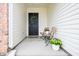 This covered porch has seating, decorations, and an inviting front entry door at 4619 Churchill Downs Cir, Greenwood, IN 46143