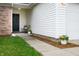 Inviting covered entry decorated with flower pots and an inviting wreath on the front door at 4619 Churchill Downs Cir, Greenwood, IN 46143
