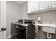 Laundry room with stainless steel washer and dryer and utility sink at 4619 Churchill Downs Cir, Greenwood, IN 46143