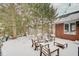 Snow covered backyard with wooden tables, wooden chairs, and exterior string lights at 4754 Austin Trce, Zionsville, IN 46077