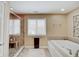 Bathroom featuring a large soaking tub and a walk-in tile and glass shower at 4754 Austin Trce, Zionsville, IN 46077
