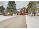 A brick two-story house featuring a large driveway with some snow, and manicured trees, offering a lovely curb appeal at 4754 Austin Trce, Zionsville, IN 46077