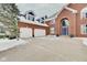 A three car garage on a brick two-story house, enhanced by dormer windows, and a well maintained driveway at 4754 Austin Trce, Zionsville, IN 46077