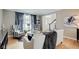 A naturally lit living room with hardwood floors, a white sofa, striped chairs, and classic decor at 4754 Austin Trce, Zionsville, IN 46077