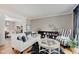 A cozy living room with hardwood floors, accented by a white sofa and striped chairs, creating an inviting space at 4754 Austin Trce, Zionsville, IN 46077