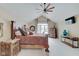 The main bedroom features vaulted ceilings, rustic furniture and a ceiling fan at 4754 Austin Trce, Zionsville, IN 46077