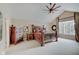 This main bedroom features a ceiling fan, many windows, and rustic-style furniture at 4754 Austin Trce, Zionsville, IN 46077