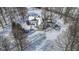An aerial view shows a home and a snowy landscape with a pool and a sunroom at 4859 W 150 N, Greenfield, IN 46140