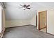 Attic area featuring broadloom carpeting, neutral decor, slanted ceilings, and a ceiling fan at 4859 W 150 N, Greenfield, IN 46140