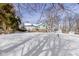 A spacious snow covered backyard features a deck, sunroom and shed and plenty of room to relax at 4859 W 150 N, Greenfield, IN 46140