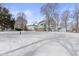 A spacious snow covered backyard features a deck, sunroom and shed and plenty of room to relax at 4859 W 150 N, Greenfield, IN 46140
