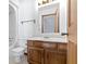 Well-lit bathroom featuring a tiled floor, wooden vanity, toilet and shower-tub combo at 4859 W 150 N, Greenfield, IN 46140