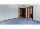 Bedroom with light blue walls and blue carpet, featuring a doorway to another room at 4859 W 150 N, Greenfield, IN 46140