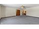 Large bedroom with neutral walls, soft carpet, and access to the bathroom at 4859 W 150 N, Greenfield, IN 46140