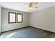 Bedroom featuring paneled windows, patterned wallpaper, carpet, and a ceiling fan at 4859 W 150 N, Greenfield, IN 46140