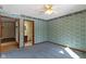 Bedroom featuring paneled windows, patterned wallpaper, carpet, and a doorway to another room at 4859 W 150 N, Greenfield, IN 46140