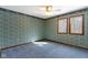 Bedroom featuring paneled windows, blue patterned wallpaper, carpet, and a ceiling fan at 4859 W 150 N, Greenfield, IN 46140