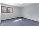 Bright bedroom with a large window and neutral-colored walls and blue carpet at 4859 W 150 N, Greenfield, IN 46140