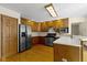 Functional kitchen with wood cabinetry, stainless steel refrigerator, and ample counter space for meal preparation at 4859 W 150 N, Greenfield, IN 46140