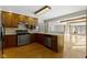 Traditional kitchen with wood cabinets, stainless steel appliances, and an open layout flowing into the living area at 4859 W 150 N, Greenfield, IN 46140