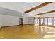 Expansive living room with wood floors, exposed beams, and abundant natural light, creating an inviting atmosphere at 4859 W 150 N, Greenfield, IN 46140